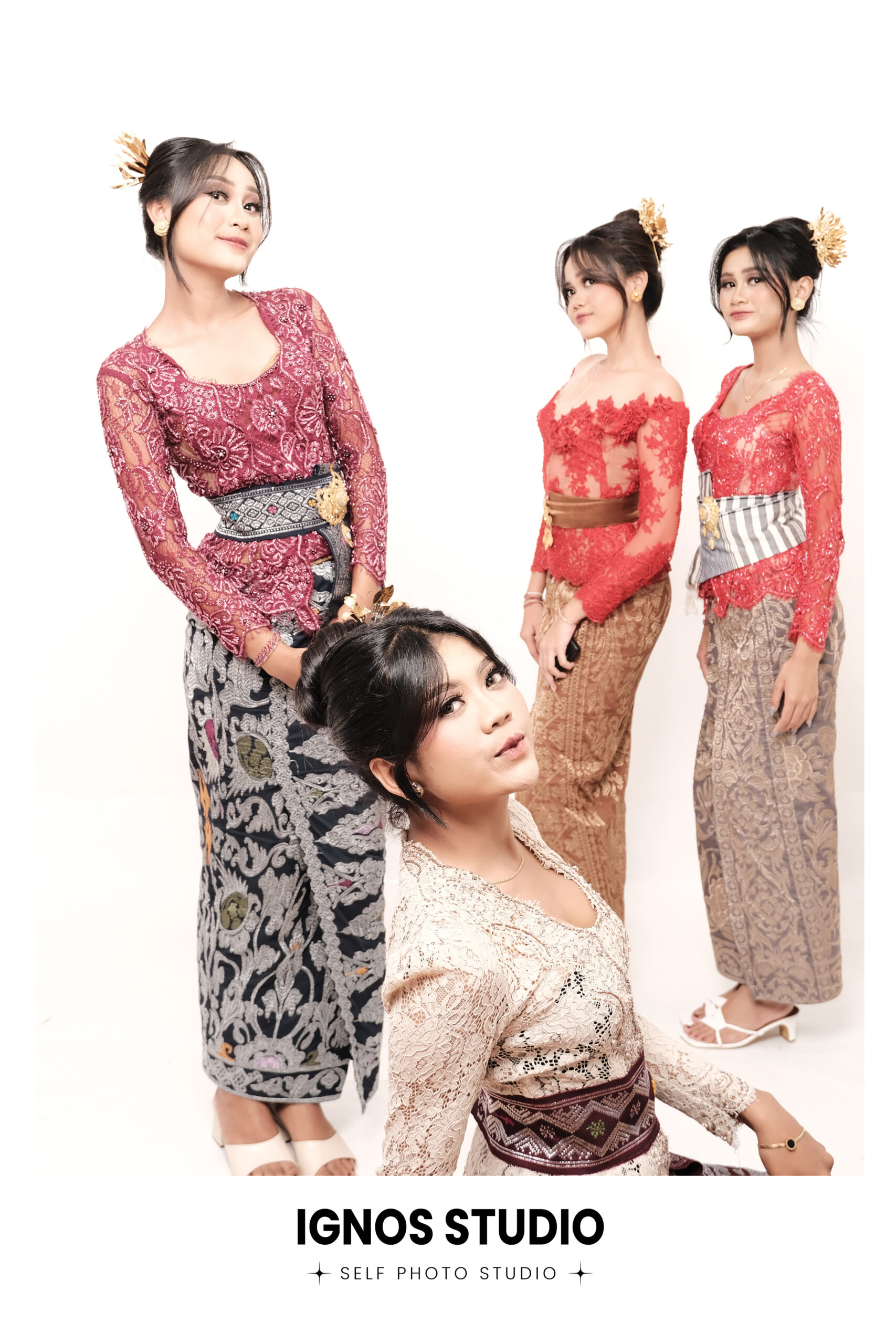 Empat wanita berpose elegan mengenakan kebaya Bali warna-warni dan kain batik di Ignos Studio.